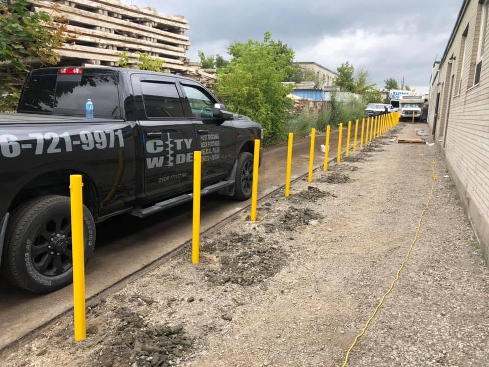 Row of new bollards along a building walkway