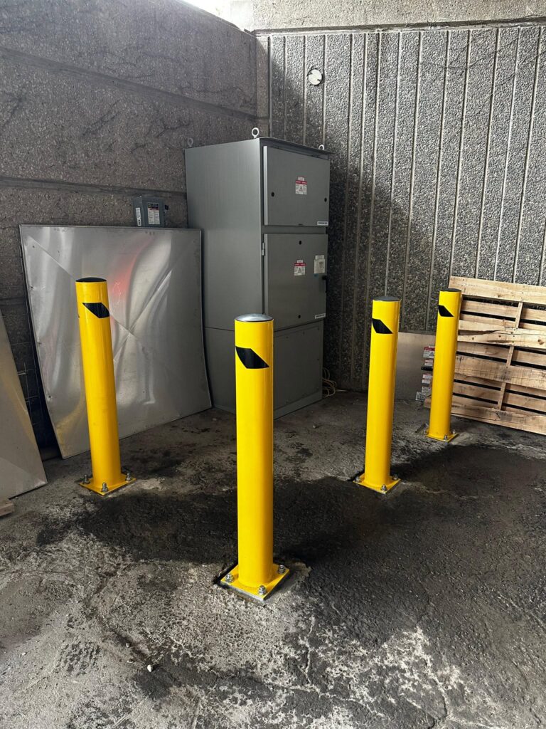 Bollards protecting electrical equipment behind a commercial building