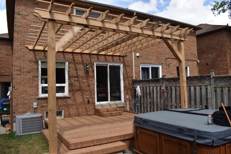 Deck with pergola and hot tub area