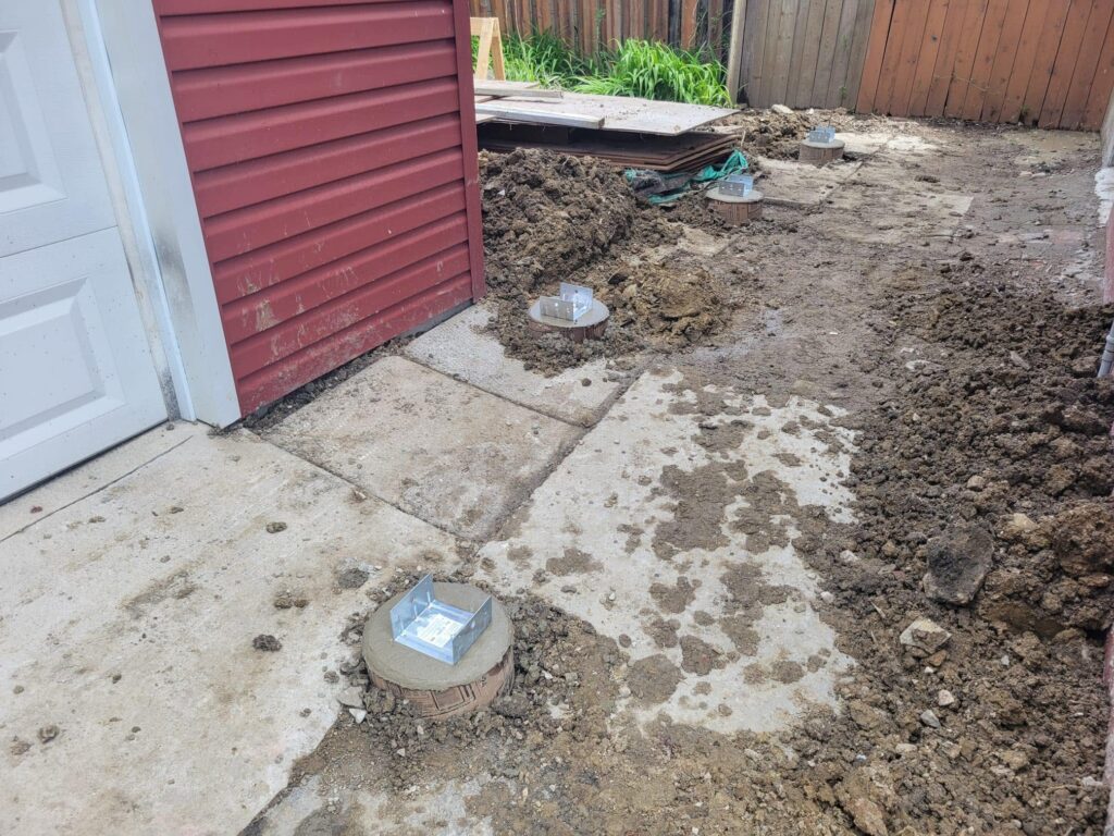 Helical pile installed next to an existing patio